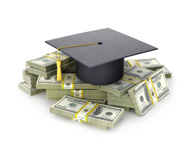 istock The graduate's hat on a bundle of dollar bill. 893490166