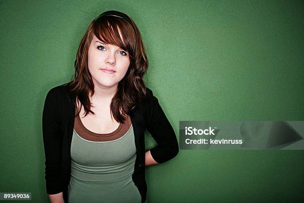 Brunette Female Against Green Wall Stock Photo - Download Image Now - 18-19 Years, Adult, Adults Only