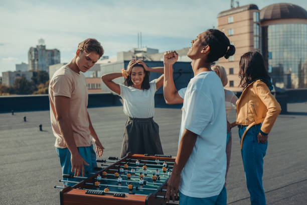 istock friends playing table football 893493102