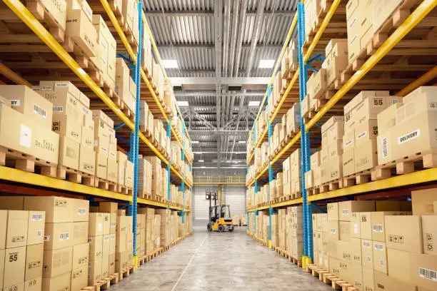 Photo of Concept of warehouse. The forklift between rows in the big warehouse
