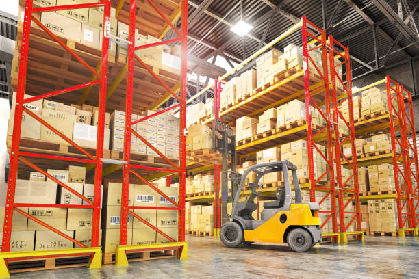 istock Concept of warehouse. The forklift between rows in the big warehouse. 893496268