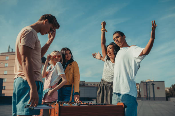 istock friends playing table football 893496320