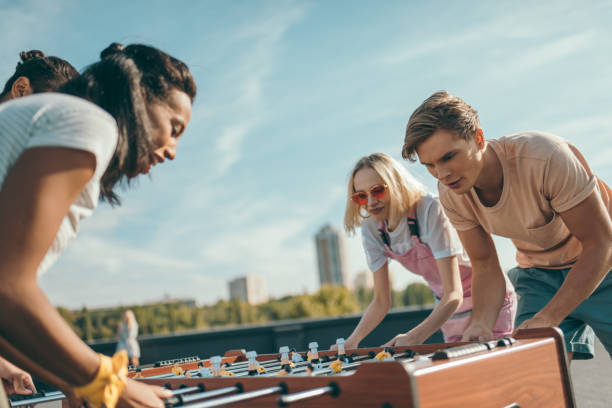 istock friends playing table football 893497420