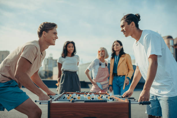istock friends playing table football 893499680