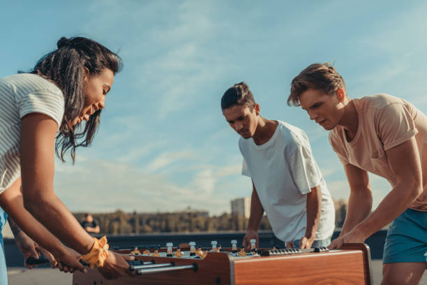 istock friends playing table football 893500202