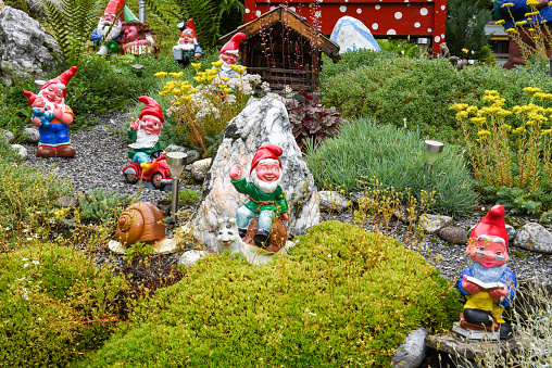 Engelberg, Switzerland - 12 July 2017: Garden gnomes in a garden of a house at Engelberg on the Swiss alps