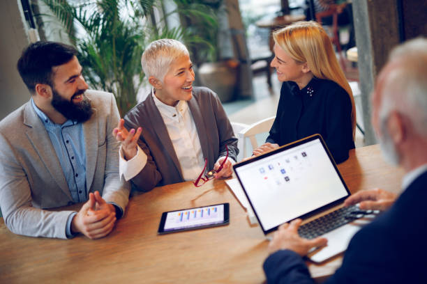 istock Mixed age business team having a meeting in cafe. 893505762