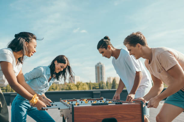 istock friends playing table football 893506110