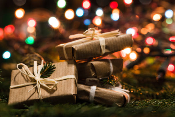 istock Christmas eve with gift boxes on lights background 893510120