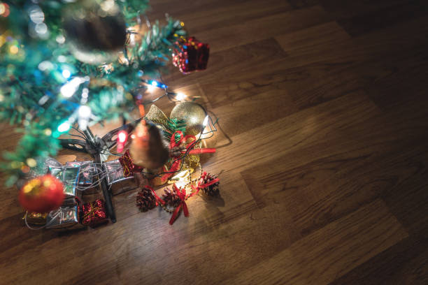 istock hristmas trees with gift boxes and decorations on wooden floor 893510918