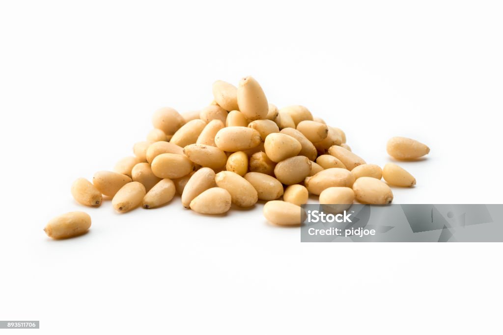 Nuts: high angle view Pile of white pine nuts on a white background Pine Nut Stock Photo