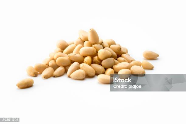 Nuts High Angle View Pile Of White Pine Nuts On A White Background Stock Photo - Download Image Now