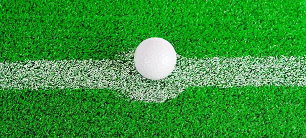 Golfball laying in the center of a small soccerfield, where is the hole ??