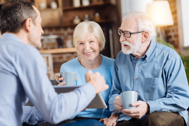istock Loving son showing something on tablet to his parents 893521652