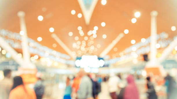 istock abstract blur image of walking way inside modern building with bokeh for background usage . (warmed tone) 893521740