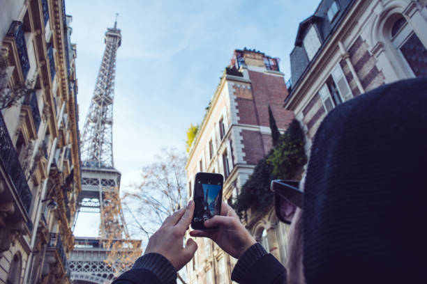 istock Man making photograph of Eiffel Tower 893525360