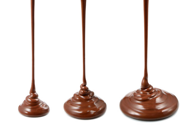 istock Stream of chocolate. Hot melted chocolate isolated on white background 893528654