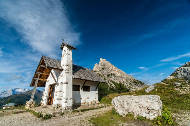 istock historic white chapel in the Dolomites 893529270