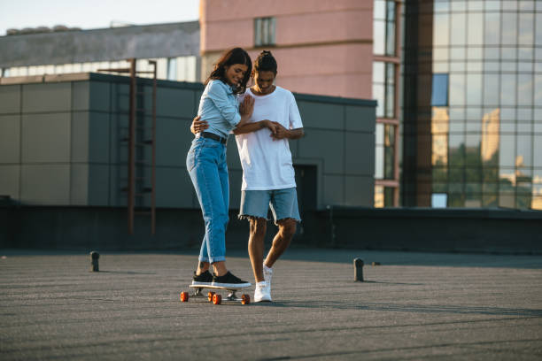 istock young woman learning to ride skateboard 893529314