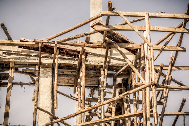 istock House under construction, showing the wooden scaffolding details. 893529356