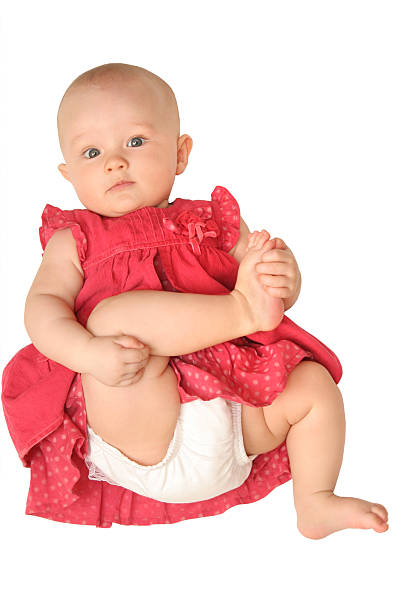 baby girl in red dress stock photo