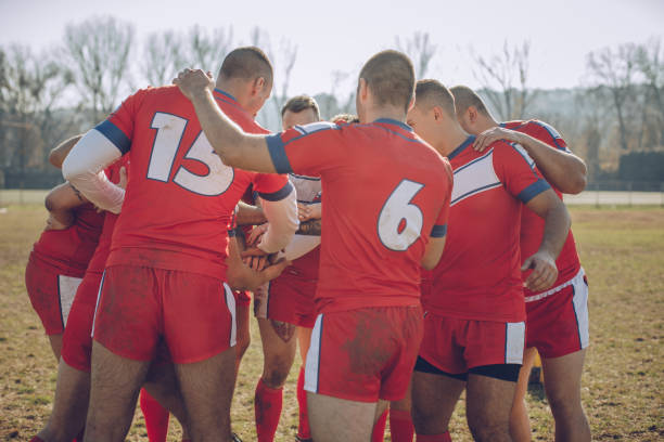 istock Group of rugby players huddling during time out 893534478