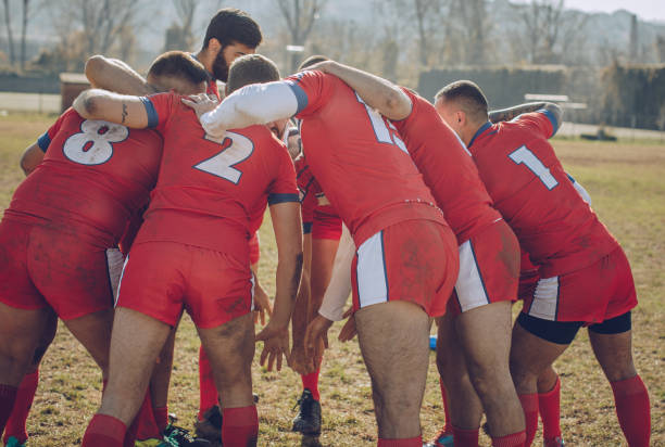 istock Group of rugby players huddling 893534570
