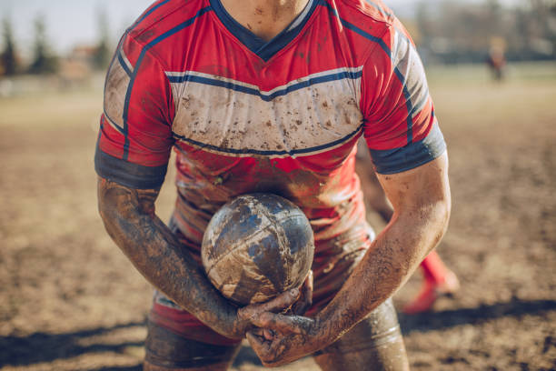 istock Rugby player standing on a playing field with ball 893534806
