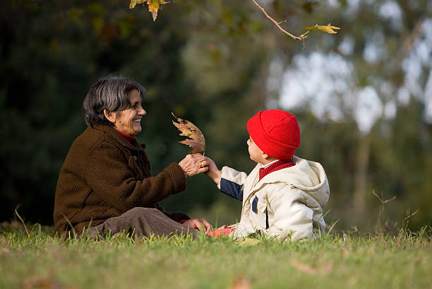 istock Grandmother and grandchild playing on meadows 89353656