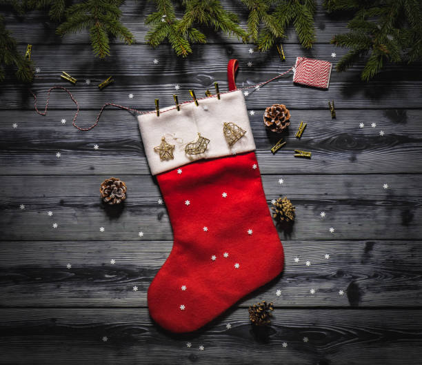 istock top view of a santa's red sock on dark boards 893544552