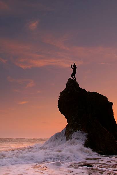 ocean sunset celebration!  rock sea malibu silhouette stock pictures, royalty-free photos & images