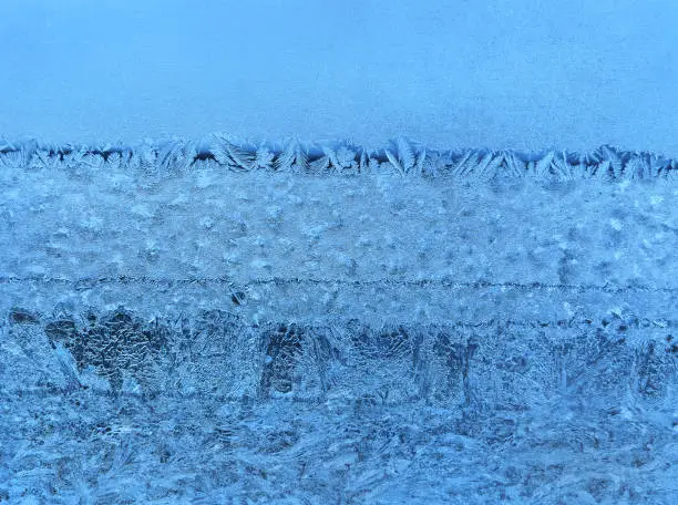 Ice natural pattern on winter window glass, close-up background