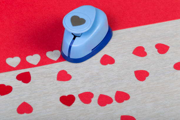 Figured Plastic Paper Punch And Handmade Red Hearts Preparation Of  Decorations For Valentines Day Wedding Or Other Romantic Event Stock Photo  - Download Image Now - iStock