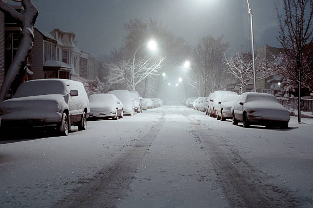 Snow-Covered Cars Lit by Street Lights - Blizzard of 2006 stock photo