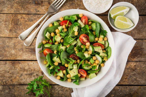 istock Avocado, tomato, chickpeas, spinach and cucumber salad 893560504
