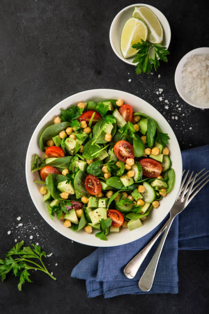 istock Avocado, tomato, chickpeas, spinach and cucumber salad 893560518