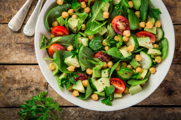 istock Avocado, tomato, chickpeas, spinach and cucumber salad 893560556