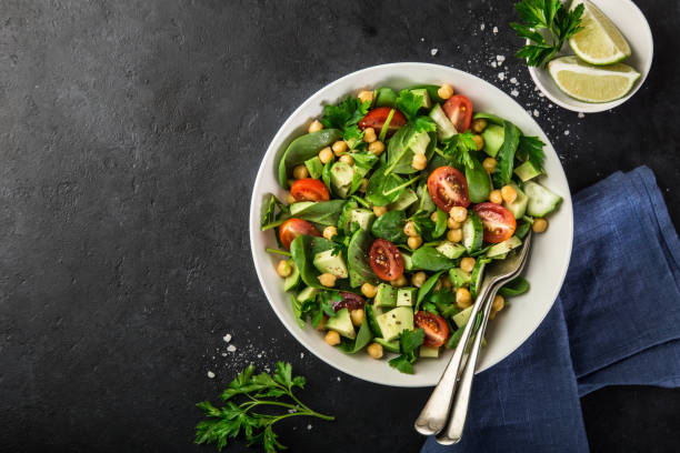istock Avocado, tomato, chickpeas, spinach and cucumber salad 893560582