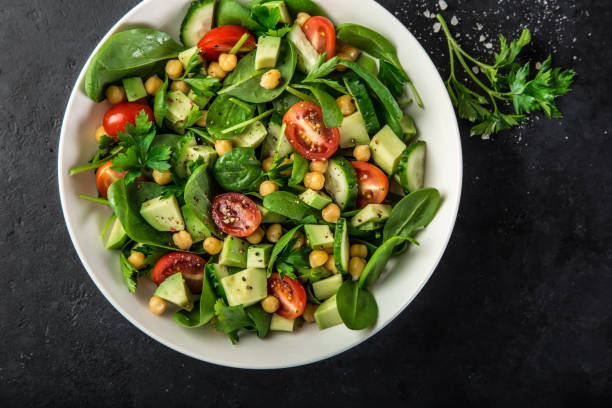 istock Avocado, tomato, chickpeas, spinach and cucumber salad 893560604