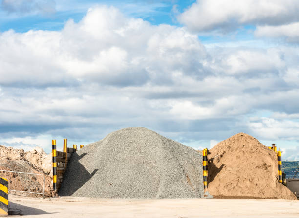 Gravel and sand mounds for concrete production Heaps of gravel and sand at a construction location, for making concrete. Aggregate supplier stock pictures, royalty-free photos & images