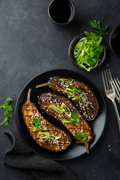 istock glazed grilled eggplants served with sesame seeds and green onion 893569122