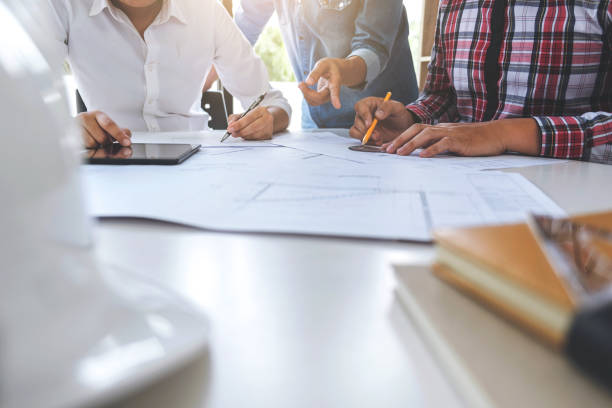 istock Architect working on blueprint, Engineer meeting working with partner colleagues and engineering tools for architectural project, Construction concept 893576792