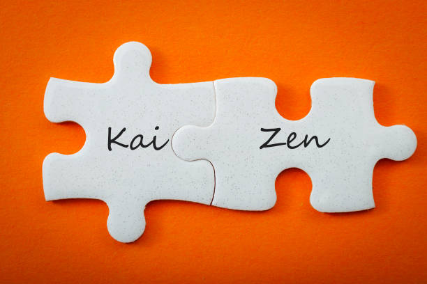 kaizen business concept with puzzle pieces Business concept and interconnected puzzle pieces that put the words “kai” meaning "continuous" and “zen” meaning "improvement" or "wisdom". Kaizen is the Japanese strategy for "continual improvement" word processing stock pictures, royalty-free photos & images