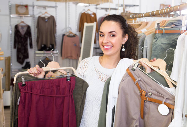 istock Girl selecting new garments at the store 893585422