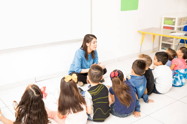 istock Preschoolers sitting in the classroom floor 893589940