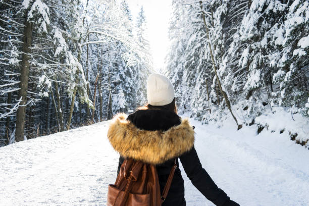 istock Young female giving back in a snow way 893593718