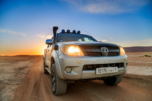 A four wheel drive car on a desert road