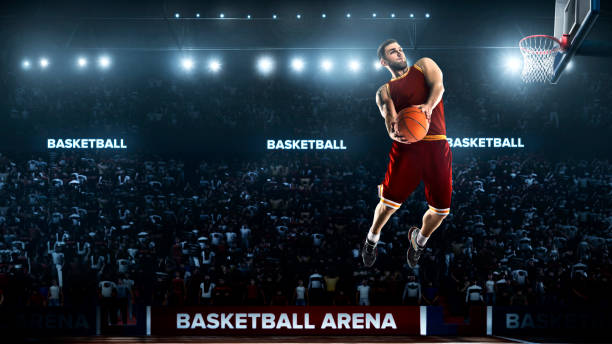 istock one basketball player jump in stadium panorama view 893599806