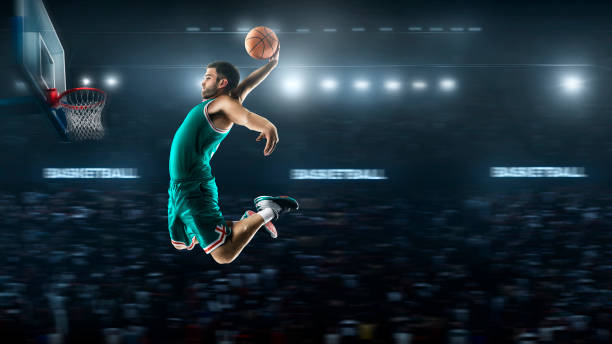 istock one basketball player jump in stadium panorama view 893599926