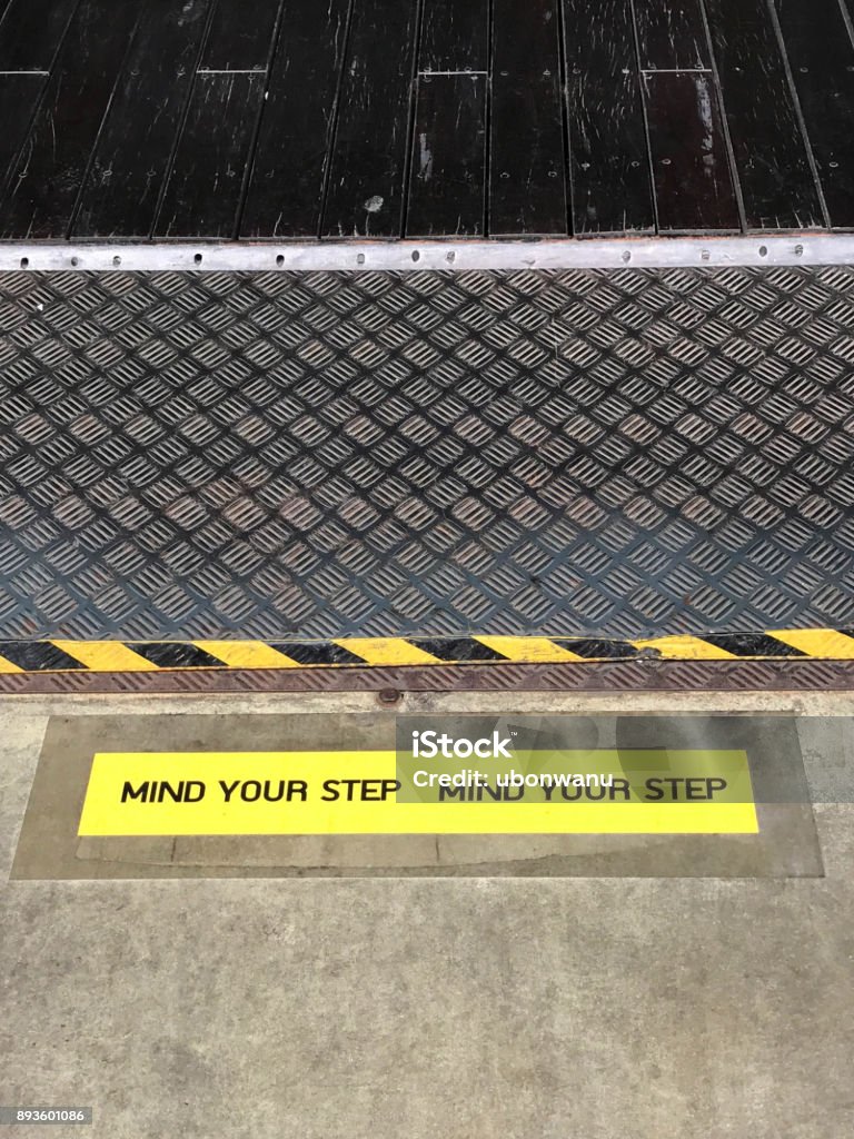 Yellow Warning Step Yellow And Black Warning Sign On Step Stating Mind Your Step Stock ...